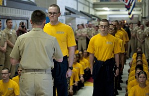 Master Chief Petty Officer of the Navy (MCPON) Mike Stevens hands recruits the first issuance of mobile devices during the launch of eSailor at Recruit Training Command.