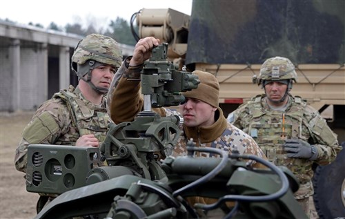 Sgt. David Snyder, gunner assigned to Bravo Battery, 1st Battalion, 119th Field Artillery Regiment, Michigan National Guard, watches Pfc. Jevgenijs Gubinskis, Latvian Land Forces, change the gunner's site controls on their M777A2 howitzer during training near Adazi, Latvia, March 24, 2015. The Michigan National Guard 1-119th FA is working with their Latvian counterparts as part of Operation Summer Shield XII, a multinational NATO training exercise whose participants include U.S. active duty Army, Reserve, and National Guard, U.S. Marines, and units from Latvia, Lithuania, Germany, Luxembourg, and Canada. Michigan and Latvia have worked together in the State Partnership Program for 23 years. (U.S. Army photo by Staff Sgt. Kimberly Bratic, Michigan National Guard/Released)