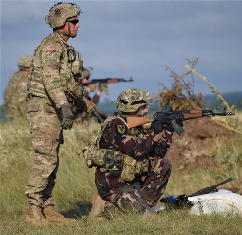 A Trooper from 5th Squadron, 7th Calvary Regiment, 1st Armored Brigade Combat Team, 3rd Infantry Division observes a Hungarian Soldier engage a target during a stress at Camp Ujamajor, Hungary July 13, 2016. The Troopers are in Hungary as a part of Operation Atlantic Resolve, a demonstration of continued U.S. commitment to the collective defense of Europe through a series of actions designed to reassure NATO allies and partners of our dedication to enduring peace and stability in the region.
