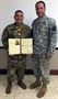 Staff Sgt. Omar Rodriguez is presented with the military order of Saint Christopher by Command Sgt. Maj. Rene Berlingeri, an Ancient Order of Saint Christopher recipient, during a ceremony on Fort Buchanan, October 23.