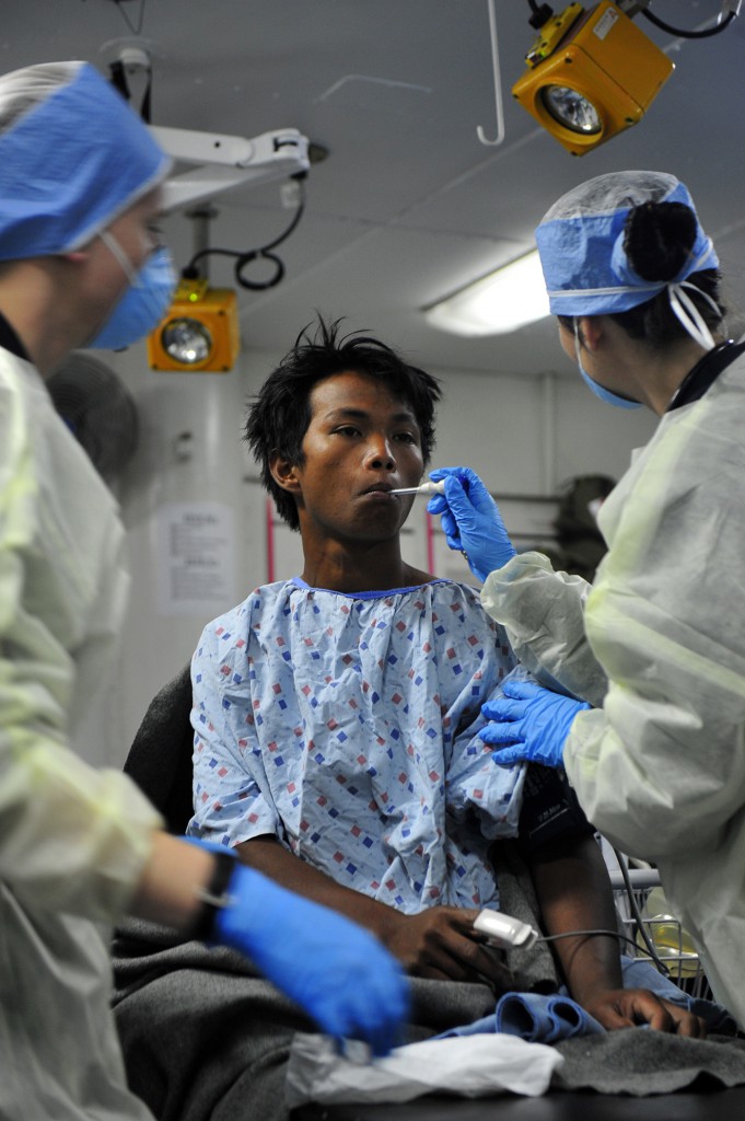 PHILIPPINE SEA (March 25, 2015) Hospital Corpsman 2nd Class Caitlin Clarke, attached to the U.S. 7th Fleet flagship USS Blue Ridge (LCC 19), provides medical treatment for one of five Filipino nationals rescued after signaling for assistance. Blue Ridge is currently on patrol strengthening and fostering relationships within the Indo-Asian Pacific region. (U.S. Navy photo by Mass Communication Specialist Seaman Apprentice Timothy Hale/Released)