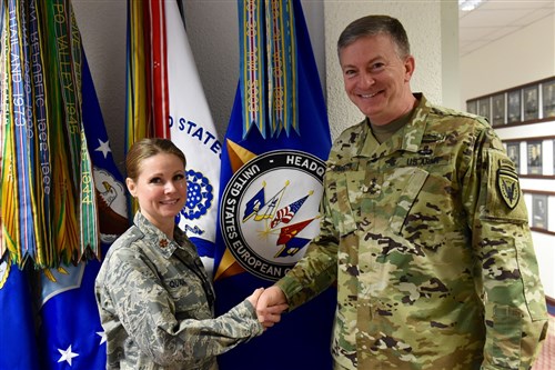 U.S. European Command Deputy Commander Lt. Gen. W. Burke Garrett III presents a coin to Maj. Wendy Quick, Chief of Special Activities Operations Center, for outstanding duty performance Apr. 15, 2016.