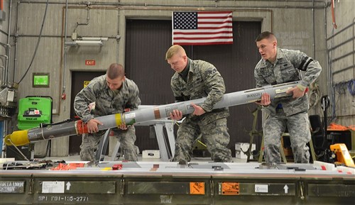 (From left) Airman 1st Class Cody Hedberg, Senior Airman Michael Bingaman and Airman 1st Class Phillip Borkowski, 31st Munitions Squadron precision guided munitions crew members, pick up an AIM-9/M missile to inspect, Feb. 26, 2013 at Aviano Air Base, Italy. Under the 31st MUNS, there are six different flights that provide armament, production, materiel, weapons, systems and programs for the 510th and 555th Fighter squadrons and the 31st Security Forces Squadron.