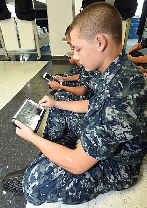 Seaman Recruit Donald Shrupp uses an electronic tablet during a study period in his barracks, USS Hopper, at Recruit Training Command (RTC).