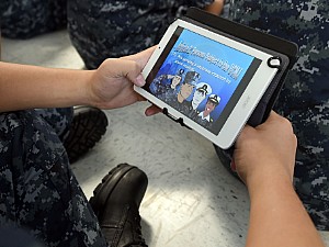 A seaman recruit uses an electronic tablet (e-tablet) to study the Uniform Code of Military Justice (UCMJ) in the USS Hopper Recruit Barracks at Recruit Training Command (RTC).