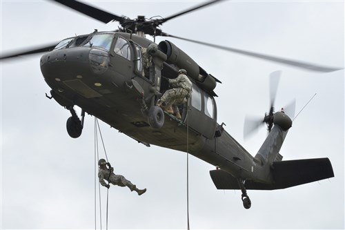 U.S. Soldiers and Airmen, assigned to various units throughout Europe, rappel from a UH-60 Black Hawk during an air assault course at the 7th Army Joint Multinational Training Command's Grafenwoehr Training Area, Germany, June 9, 2015. The course is being conducted through the 7th Army Combined Arms Training Center by a mobile training team from Ft. Bragg and marks the first time the Air Assault Course has been held at the newly-built and renovated air assault facilities of the Grafenwoehr Training Area. (U.S. Army photo by Visual Information Specialist Markus Rauchenberger/released)