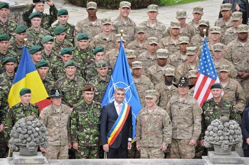 Command Sgt. Maj. Peter D. Johnson (bottom middle left), Squadron command sergeant major assigned to 2nd Squadron, 2nd Cavalry Regiment, stands with Vlad Oprea (bottom middle), mayor of Sinaia, along with Brig. Gen. Michael J. Tarsa (bottom middle), 4th Infantry Division deputy commanding general, and Lt. Col. Theodore A. Johnson (bottom middle right), 2nd Squadron commander, as they pose with other leaders from the Romanian Land Forces and 2nd Squadron, at Peles Castle located in Sinaia, Romania, during the unit's Cavalry March from Mihail Kogalniceanu Air Base to the Cincu Training Center, May 14, 2015. This event will not only focus on transporting troopers and their equipment to a new Romanian training facility, but it will also give the unit a chance to interact with the local populace while improving on relations with their host nation in support of Operation Atlantic Resolve-South. (U.S. Army photo by Sgt. William A. Tanner/released)