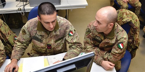 NCOs Rosario Fazzone (left) and Simone Rafaelli of 186th Parachute Regiment, Folgore Brigade, monitor operations during Command Post Exercise training at the Vicenza Mission Training Complex on Caserma Ederle Jan. 29, 2013. The paratroopers, stationed in Pisa and Livorno, traveled to Caserma Ederle to conduct a regimental level Command Post Exercise, or CPX. The rotation was the latest in an ongoing series of joint trainings and exchanges with their airborne partners, the Sky Soldiers of the 173rd Airborne Brigade Combat Team.