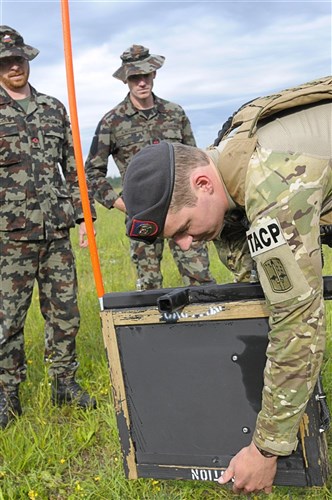 U.S. Air Force Airman 1st Class Anthony Abel, a ROMAD with the 2nd Air Support Operations Squadron, demonstrates an Improvised Explosive Device countermeasure called a Rhino to Slovenian army personnel during the opening ceremony for Allied Strike 2011. 