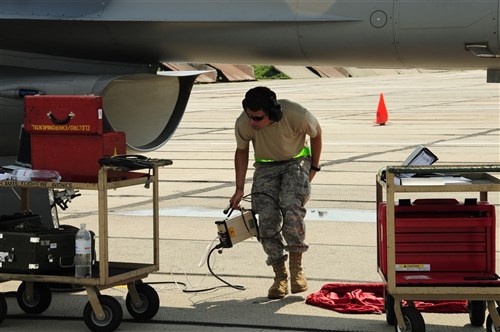 Master Sgt Lance Smith, a propulsion supervisor from the Alabama Air National Guard, carries a test set to work on an F-16 while assisting in SAFE SKIES 2011 at Mirgorod Air Base, Ukraine.  The Air National Guard is in Ukraine supporting SAFE SKIES 2011, a 2-week multinational flying event preparing Ukraine and Poland to better protect their airspace during the 2012 EUROPCUP.   (U.S. Air Force Photo by Tech. Sgt. Charles Vaughn, 144 FW/PA / Released)