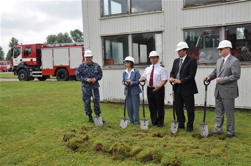 LIMBAAAI, Latvia &mdash; On July 8, (from left) Navy Rear Adm. William &#34;Andy&#34; Brown, U.S. European Command director of logistics, Judith Garber, U.S. Ambassador to Latvia, and Latvian officials ceremoniously break ground on the renovation of a small fire station in Limbazi in northen Latvia. As part of a EUCOM-funded civil-military operation, the project will upgrade lighting and electrical systems as well as install new overhead roll-up doors at the station. The renovation is the first in a series of 10 fire station refurbishment projects planned throughout Latvia over the next five years that will retrofit new overhead vehicle doors required to support new fire and rescue trucks received as part of the European Union-funded donation. The project is being managed by the U.S. Army Corps of Engineers Europe District. (U.S. Army phtoo by Navy Lt. Cmdr. Duc Nguyen)