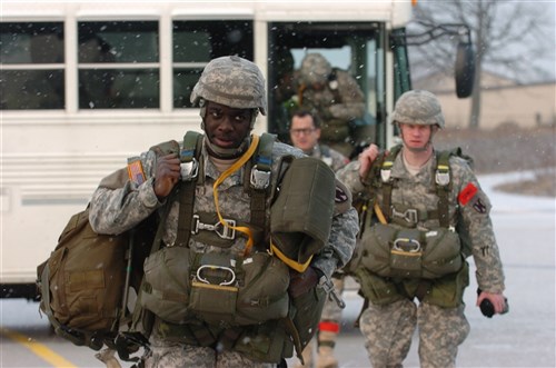 RAMSTEIN AIR BASE, Germany &mdash; Soldiers from the 5th Quartermaster Company, 21st Special Troops Battalion, 21st Theater Sustainment Command, step off a bus to board an Air Force C-130J Super Hercules cargo plane here, Feb. 10. 5th QM conducted a jump with the drop zone near Marnheim, Germany. (U.S. Army photo by Spc. Amanda Rigdon)