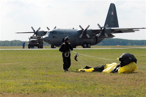 Members of Polish special forces land during high-altitude, low-opening jumps with Air Force jumpmasters during Exercise Screaming Eagle IV in Povidz, Poland, July 30, 2012. Screaming Eagle is an annual exercise that allows pilots from the 37th Airlift Squadron to conduct training with the C-130J Super Hercules aircraft, while facilitating training for several other units.