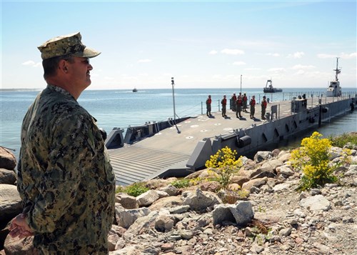 PALDISKI HARBOR, Estonia - Chief Warrant Officer Tim Gordon(left) observes as Sailors from Naval Beach Group Two, an element of the Maritime Prepositioning Force, demonstrate the capabilities of a causeway ferry, part of the Navy Improved Lighterage System, during the Baltic Operations (BALTOPS) 2012 Maritime Prepositioning Force demonstration, June 14. This is the 40th iteration of BALTOPS, a maritime exercise intended to improve interoperability with partner nations by conducting realistic training at sea.