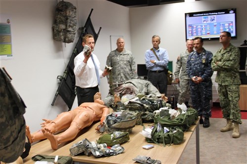 GRAFENWOEHR - Participants of the 2012 Combatant Commander's Conference observe a medical training simulation demonstration while touring the Joint Multinational Simulations Center facilities 22 August 2012. The conference, which takes place 22 and 23 August at the Joint Multinational Training Command, or JMTC, in Grafenwoehr, Germany is hosted by the United States Army in Europe and brings Europe's combatant commanders and senior enlisted advisor's together to discuss issues, challenges and opportunities to develop interoperability and unity of effort. The JMTC is the U.S. Army's largest overseas training command and regularly provides U.S. and international Soldiers facilities and opportunities to train in a sophisticated, complex, and real-time battle environment. 