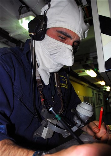 SOUDA BAY, Greece &mdash; An Italian Marine demonstrates his job as a phone talker during a fire simulation drill aboard the Italian Navy corvette Comandante Cigala Fulgosi (P 490) during exercise Phoenix Express 2009, April 29. Marines from Italy hosted damage control training aboard the ship to Phoenix Express participants from Turkey, Spain, and the U.S. (Department of Defense photo by Navy Mass Communication Specialist 1st Class Jenniffer Rivera)