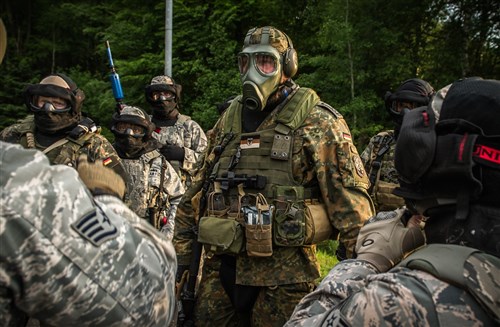 U.S. and European security forces discuss their strategy prior to breaching a hardened facility during a combat training course on Ramstein Air Base, Germany, May 30, 2015. Battlefield Leaders Assaulter Course, Integrated Combat Essentials -- or BLAC ICE is designed to teach security forces members from multiple countries advanced tactics and shooting skills for use in the event of a base security breach. (U.S. Air Force photo/ Tech. Sgt. Ryan Crane)