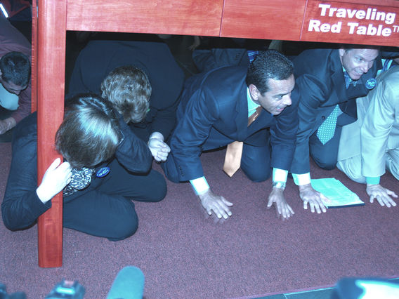 Los Angeles, Calif., Oct. 18, 2012 -- FEMA Region IX Administrator Nancy Ward, Lucy Jones of USGS, and Los Angeles Mayor Antonio Villaraigosa demonstrates the Drop, Cover, Hold On process at ShakeOut LA.