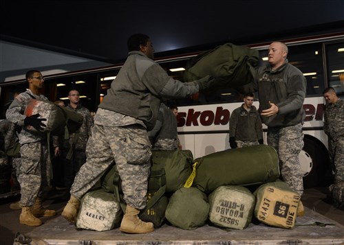 U.S. Army Spc. Gregory Brinson, center, and Staff Sgt. Paul Emory, both with the 10th Army Air and Missile Defense Command, stack deployment bags on an aircraft pallet Jan. 9, 2013, at Ramstein Air Base, Germany. Soldiers with the unit were preparing to deploy to Turkey to operate Patriot missile batteries along the Turkish-Syrian border. U.S. and NATO Patriot batteries and personnel deployed to Turkey in support of NATO's commitment to defending Turkey's security during a period of regional instability. 