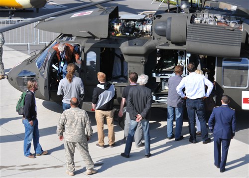 BERLIN - Aircraft industry representatives view a UH-60 Black Hawk during the Berlin Air Show, commonly known as ILA 2012, Sept. 13, 2012. The air show is an international event hosted by Germany and more than 50 U.S. military personnel from bases in Europe and the United States are here to support the various U.S. military aircraft and equipment on display. Other U.S. military aircraft featured at ILA 2012 are the UH-72A Lakota, F-16C Fighting Falcon, C-17 Globemaster III, and C-130 Hercules.