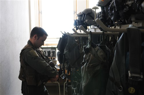 NAMEST AIR BASE, Czech Republic -- Capt. Bennet Merriman, 81st Fighter Squadron A-10 Thunderbolt II pilot, puts on his flight equipment before a close air support and forward air control training mission Sept. 10, during Ramstein Rover 2012 here. RARO 12 is a NATO partnership building exercise involving more than 16 nations. A-10 Thunderbolt IIs from the 81st FS are participating in the exercise to provide close air support to partnering nations and practice forward air control missions with their NATO allies in international security assistance force realistic scenarios. During this mission the 81st FS pilots supported German and Italian forward air controllers. Participating in exercises like RARO 12 ensures effective employment of airpower in support of alliance or coalition forces while mitigating risks to civilians in contingency operations. 