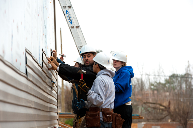 Volunteers from Habitat for Humanity build two new homes for tornado survivors.  Jewish and Muslim New York University student and staff volunteer at the job site work side-by-side.  FEMA funding and coordination with volunteer agencies help make cooperation like this possible.