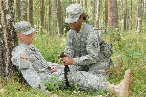 GRAFENWOEHR, Germany - U.S. Military Academy Cadet Jessica Williams applies a tourniquet to a casualty during the validation phase of the 2011 U.S. Army Europe Expert Field Medical Badge event, July 27, 2011. USMA cadets are in Grafenwoehr this summer as part of the Academy's Cadet Troop Leadership Training program, where they get a hands-on experience with the soldiers they will be working with once they are commissioned 2nd lieutenants after graduation. (U.S. Army photo by Spc. Mary Hogle)