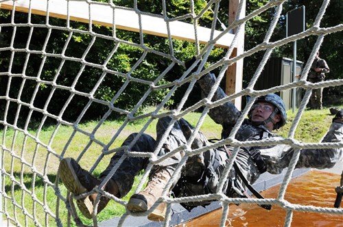 Sgt. Alfonso Bernal-Stevens, from the 421st Multifunctional Medical Battalion, secures the net during one of the obstacles on the German Obstacle Course during the 2011 Europe Regional Medical Command Expert Field Medical Competition in Baumholder, Germany October 21. (Sgt. 1st Class Christopher Fincham 30th Medical Command (DS) PAO NCOIC)