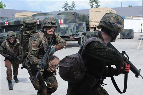 Bundeswehr soldiers rush into the Viper Pit during Combat Live Saver training May 12 in Wiesbaden, Germany.