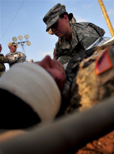 A U.S. soldier is treated by U.S. Army Medic during a medical exercise that is part of Austere challenge 2012, at Bed Ezra, Israel, Oct. 22, 2012. The 10th AAMDC soldiers participate in the joint Austere challenge 2012 exercise with Israeli Defense Forces to develop partnered air and missile defense capabilities.