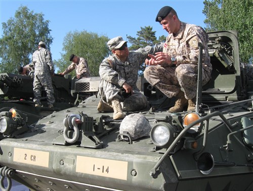 Adazi, Latvia – Spc. Adam Torres, a native of Austin, Texas, assigned to the 3rd Squadron, 2nd Cavalry Regiment explains the capabilities of a Stryker vehicle to a Latvian Soldier, at the Exercise Saber Strike 2012 ice breaker event here, on June 9. Saber Strike 2012 is a U.S. Army Europe led, multinational exercise based in Estonia and Latvia.