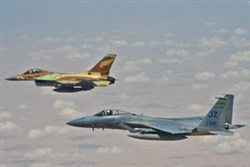 An Israeli F-16 and an F-15 from the Louisiana Air National Guard fly in formation in an orientation flight over the Nevatim Desert in southern Israel as part of Juniper Stallion 13, July 18, 2013. JS13 is an annual exercise with no relation to current real-world events.