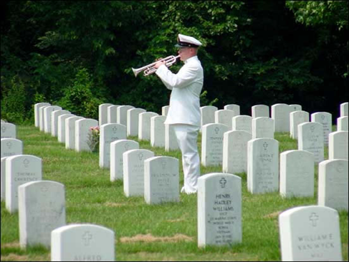 A Navy bugler sounds "Taps" at Arlington National Cemetery.