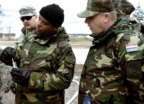 RAMSTEIN AIR BASE, Germany &mdash; U.S. Air Force Reserve Staff Sgt. Maurice Wakins and Private 1st Class Stanko Bosnjak test water they have just purified using the H9518-1 reverse osmosis water purification unit. This year&#39;s Silver Flag Exercise hosted here Feb. 21-28 allowed USAFE Airmen, Air Force Reserve and members of the Croatian Army for the first time to observe how Airmen prepare to deploy to austere locations. (U.S. Air Force photo Tech. Sgt. Michael Voss)
