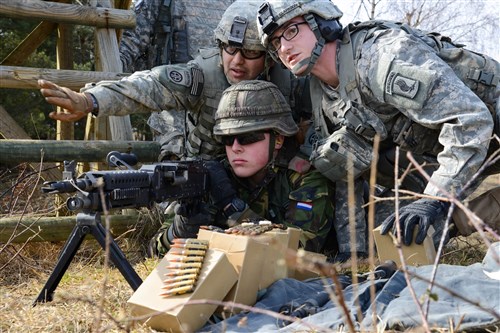 U.S. Army paratroopers, assigned to the 173rd Airborne Brigade Special Troops Battalion and a Dutch soldier with the 411th Engineer Company, 41st Armored Engineer Battalion, 13th Mechanized Infantry Brigade, Royal Netherlands Army, engage targets during a combined defensive live-fire exercise at the 7th Army Joint Multinational Training Command's Grafenwoehr Training Area, Germany, March 7, 2015. The 173rd Airborne routinely trains alongside NATO forces to increase interoperability and strengthen the alliance. (U.S. Army photo by Pfc. Nathanael Mercado/Released)