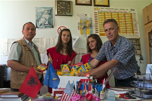 IVAJE/IVAJA, Kosovo &mdash; Naim Hysa, Kacaniku/Kacanik Red Cross director, stands with Isa Rexha, school director, in Ivaje/Ivaja, Kosovo, Domjeta Tromi, Erona Thaqi, Red Cross youth volunteers, and school supplies donated by students in Oakes, N.D. The supplies were transported by U.S. NATO Kosovo Force soldier Army Staff Sgt. Andrew T. Gilbertson, Oakes, N.D., June 14, who also taught history at Oakes High School, to be delivered to six Kacaniku/Kacanik schools. (U.S. Army photo by Sgt. Joshua Dodds)