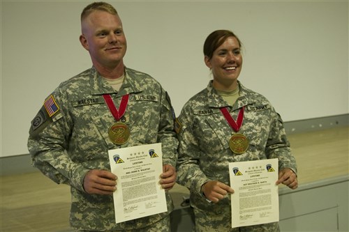 Staff Sgt. Jesse H. Walstad and Sgt. Heather R. Barta smile as they display their medallion and certificate after their induction ceremony, by Sgt. Maj. Grant Jones, Sgt. Maj. Grant Jones, the USAREUR operations sergeant major, June 25 at Medal of Honor Hall at Camp Bondsteel, Kosovo. (photos by Sgt. Joshua Dodds, 116th Public Affairs Detachment)