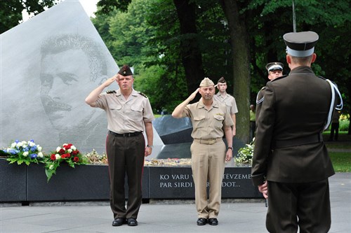 RIGA, Latvia &mdash; Navy Adm. James Stavridis and Latvian army Maj. Gen. Raimonds Graube, Latvian Chief of Defense, render honors at a wreath laying ceremony at Colonel O. Kalpaks Memorial Monument in Latvia where Stavridis made an official visit July 13-14. (Department of Defense photo)