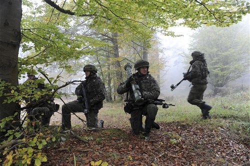 A Polish soldier allied with U.S. Army Europe's 173rd Airborne Brigade Combat Team, scans for a target during an engagement with opposing forces during Europe's Full-Spectrum Training Environment, Oct 23, 2011. The FSTE was hosted by the Joint Multinational Training Command at Grafenwoehr and Hohenfels Training Areas in Germany.