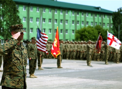 VAZIANI TRAINING AREA, Republic of Georgia-In front of a color detail with the national colors of America and the Republic of Georgia and the unit colors of the U.S. Marine Corps and Georgian military, Maj. Eric J. Andersen, executive officer Black Sea Rotational Force 11 and Kent, Wash., native,  â?forms the troops for the opening ceremony of Exercise Agile Spirit 2011, marking the official start of what is scheduled to be an annual training event with the partner nation. Marines with Alpha Company of Anti-Terrorism Battalion, and 4th Light Armored Reconnaissance Battalion deployed to Georgia for their annual training to supplement the Special Purpose Marine Air-Ground Task Force deployment of BSRF-11, to conduct counterinsurgency and peacekeeping operations training at Vaziani Training Area. , Cpl. Tatum Vayavananda