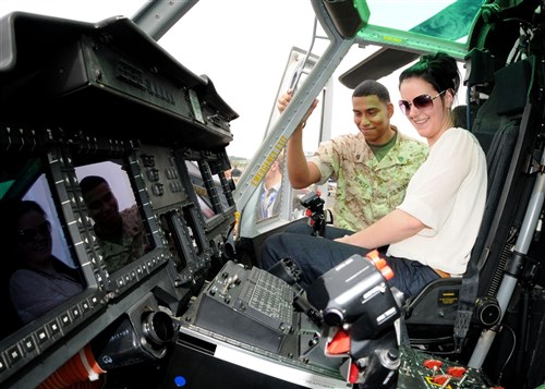 FARNBOROUGH, United Kingdom  â? Marine Sgt. Marlin Benitez, with the Light Attack Helicopter Squadron 367 (HMLA 367), Camp Pendleton, California, explains the features in the cockpit of a UH-1Y to Shona Waddell at the Farnborough International Air Show July 20.  Benitez is part of approximately 70 other aircrew and support personnel from bases in Europe and the United States that participated in the air show. (U.S. Air Force photo by  Staff Sgt. Jerry Fleshman)
