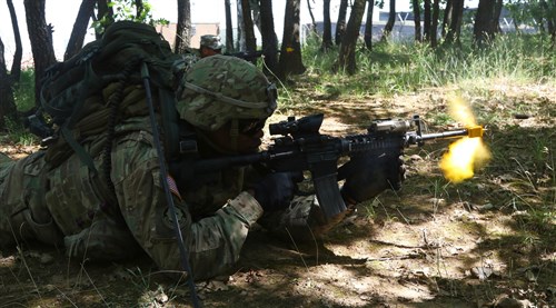 Sgt. Dalvin Carr, an infantryman assigned to Alpha Company, 1st Battalion, 41st Infantry Regiment, 2nd Infantry Brigade Combat Team, returns fire against a simulated enemy during day one of the Multinational Battle Group-East's Best Warrior Competition held on Camp Bondsteel, Kosovo, July 9. (U.S. Army photo by: Staff Sgt. Thomas Duval, Multinational Battle Group-East Public Affairs)