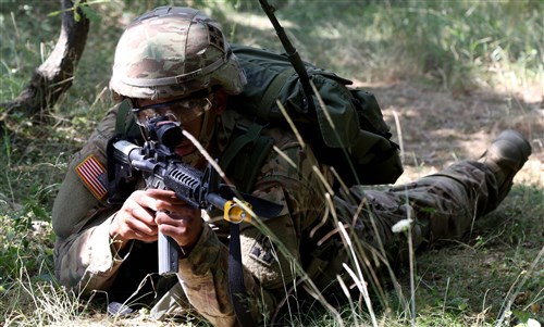 Pfc. Jordan White, an infantryman assigned to the 1st Battalion, 41st Infantry Regiment, 2nd Infantry Brigade Combat Team pulls security for his squad during the Multinational Battle Group-East's Best Warrior Competition held on Camp Bondsteel, Kosovo, July 9. (U.S. Army photo by: Staff Sgt. Thomas Duval, Multinational Battle Group-East public affairs)