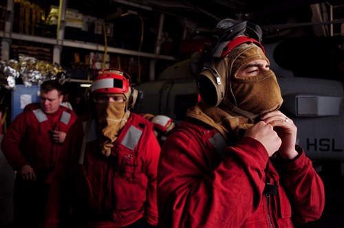 SOUDA BAY, Greece (Feb. 9, 2012) - Damage Controlman 3rd Class Michael Macenany (right), Seaman Troy Keller (center) and Engineman 2nd Class Zachary Marvain (left) don firefighting gear in the hangar bay of the guided-missile cruiser USS Vella Gulf, for a firefighting training drill on the ship's flight deck while in port Souda Bay. Vella Gulf, homeported out of Norfolk, Va., is currently conducting theater security cooperation and maritime security operations in the U.S. 6th Fleet area of responsibility. 