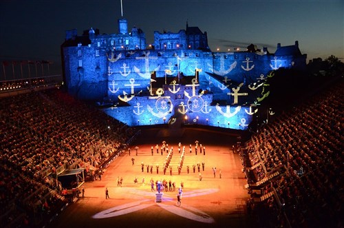 U.S. Naval Forces Europe Band musicians perform "Anchors Aweigh" as technicians project Navy imagery onto Edinburgh castle during a Royal Edinburgh Military Tattoo dress rehearsal for charities and local Edinburgh citizens. This military tattoo brings together musicians, dancers and bagpipers from around the world to perform in Europe’s most prestigious military tattoo and this year marks the first time since 1950 that a Navy band has performed in the show.