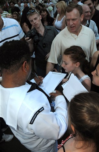ODESSA, Ukraine (June 7, 2011)Musician 2nd Class Kori Gillis of Commander, U.S. Naval Forces Europe, rock band, Flagship, signs autographs for the local community after performing a concert in the Gorsad Gardens during exercise Sea Breeze 2011. Air, land and naval forces from Azerbaijan, Algeria, Belgium, Denmark, Georgia, Germany, Macedonia, Moldova, Sweden, Turkey, Ukraine, the United Kingdom and the United States will participate in Sea Breeze, the largest multinational maritime exercise this year in the Black Sea, June 6-18, and is co-hosted by the Ukrainian and U.S. Navies. 
