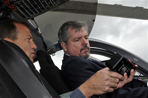 Gregory Barth Program Executive Office Aviation avionics lead shows Michael Ryan European Command interagency partnering how the hand controller for an MX-15i works on board of an U.S. Army UH-72A Lakota, July 10, 2012, during the Farnborough International Air Show in Farnborough, England. The Lakota is a state-of-the-art aircraft with twin engine reliability, a 21st century navigation/communication system, and a proven record of commercial aviation service. Approximately 90 aircrew and support personnel from bases in Europe and the United States are participating in the air show. Participation in this premier event demonstrates that U.S. defense industry offers state-of-the-art capabilities vital for the support and protection of our allies’ and partners’ national-security interests.