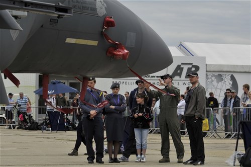 U.S. Air Force Capt. Christopher York, 492nd Fighter Squadron pilot, talks with visitors about the various capabilities of an F-15E Strike Eagle, July 15, 2012, during the Farnborough International Air Show in Farnborough, England. Approximately 90 aircrew and support personnel from bases in Europe and the United States are participating in the air show. More than 250,000 trade and public visitors attend the bi-annual event which concluded today. 