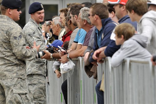 U.S. Air Force Senior Airman Corey Moore, 48th Security Forces Squadron patrolman, talks with visitors, July 15, 2012, during the Farnborough International Air Show in Farnborough, England. Approximately 90 aircrew and support personnel from bases in Europe and the United States are participating in the air show. More than 250,000 trade and public visitors attend the bi-annual event which concluded today.