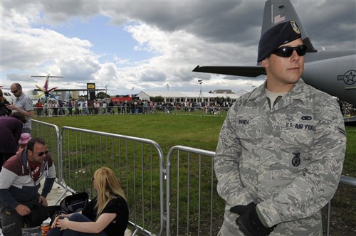 U.S. Air Force Airman 1st Class Andrew Banda, 48th Security Forces Squadron security patrolman, stands guard at the U.S. military static display corral, July 15, 2012, during the Farnborough International Air Show in Farnborough, England. Approximately 90 aircrew and support personnel from bases in Europe and the United States are participating in the air show. More than 250,000 trade and public visitors attend the bi-annual event which concluded today. 